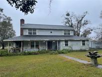 Two-story house with a wraparound porch and large yard at 5007 Booth Rd, Plant City, FL 33565