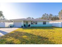 Ranch-style home with a well-maintained lawn and attached garage at 960 43Rd Ne Ave, St Petersburg, FL 33703