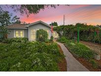 Charming bungalow with lush landscaping and walkway at 546 Orangewood Dr, Dunedin, FL 34698