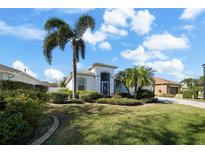 House exterior showcasing a palm tree and well-manicured lawn at 10038 Reagan Dairy Trl, Bradenton, FL 34212