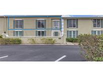 Attractive exterior of a light tan multi-unit building with green door at 1157 Eden Isle Ne Blvd # 3, St Petersburg, FL 33704