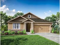 One-story home with tan exterior, brown roof, and landscaping at 34940 Mulrion Dr, Zephyrhills, FL 33541