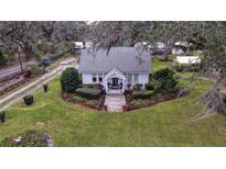 Charming house with landscaped yard and driveway, seen from above at 4156 Mcintosh Rd, Dover, FL 33527