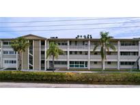Two-story residential building with palm trees and landscaping at 4455 Duhme Rd # 303, St Petersburg, FL 33708