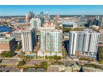 Aerial view of a luxury condo building with city skyline and amenities at 450 Knights Run Ave # 705, Tampa, FL 33602