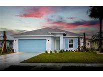 New single-story home with light blue garage door and landscaping at 573 Rose Apple Cir, Port Charlotte, FL 33954