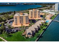 Aerial view of waterfront condo community with pool and boat dock at 7432 Sunshine Skyway S Ln # 206, St Petersburg, FL 33711