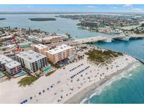 Aerial view of beachfront property with pool and ocean access at 12924 Gulf Blvd # 307, Madeira Beach, FL 33708