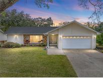 Single-story home with a large yard and attached garage at 1559 Glengarry Dr, Palm Harbor, FL 34684
