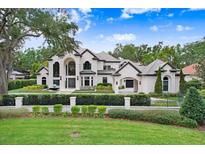 Stunning two-story home with a beautifully landscaped lawn and a black fence at 16220 Villarreal De Avila, Tampa, FL 33613