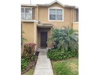 Inviting exterior featuring a charming townhouse with a well-maintained walkway and landscaping at 6603 Osprey Lake Cir, Riverview, FL 33578