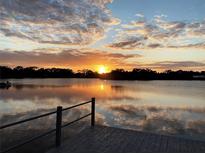 Stunning sunset over calm water, seen from a private dock at 7127 Peninsular Dr, New Port Richey, FL 34652