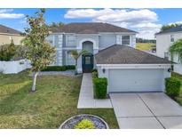 Two-story house with gray siding, dark green door, and a two-car garage at 11120 Kempton Vista Dr, Riverview, FL 33579