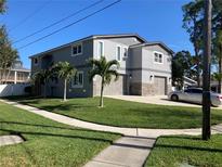 Two-story house with gray siding, stone accents, and a two-car garage at 1600 Pennsylvania Ne Ave, St Petersburg, FL 33703