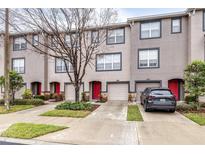 Townhouse exterior with 3-unit building, 2-car garages, and landscaping at 2547 Lexington Oak Dr, Brandon, FL 33511