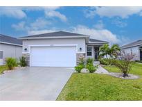 One-story home with a white garage door and landscaped lawn at 2564 89Th Street E Cir, Palmetto, FL 34221