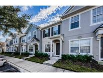 Row of modern townhomes with neutral gray exteriors, well-maintained landscaping, and inviting entryways at 10425 Westpark Preserve Blvd, Tampa, FL 33625