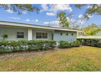 Ranch style home with light blue exterior, well-manicured lawn, and hedges at 11200 102Nd Ave # 138, Seminole, FL 33778