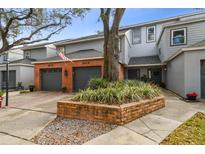 Inviting exterior of a two-story townhome with a brick facade and landscaped front yard at 2519 Crowder Ln, Tampa, FL 33629