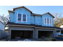 Two-story house under construction with gray siding and attached garages at 2708 W North A St # 1, Tampa, FL 33609