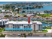 Aerial view of waterfront building, showing the complex and surrounding boats at 300 150Th Ave # 502, Madeira Beach, FL 33708