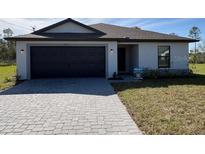 Newly constructed home with a modern facade and paved driveway at 4294 Danbury St, North Port, FL 34286