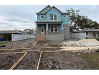 Two-story craftsman style home under construction with a front porch and landscaping at 441 42Nd Ne Ave, St Petersburg, FL 33703