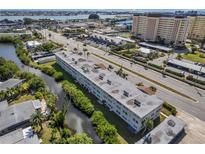 Aerial view of condo building near water, showing surrounding landscape and nearby buildings at 4455 Duhme Rd # 305, St Petersburg, FL 33708