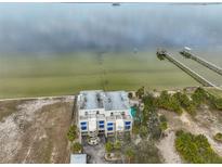 Aerial view of waterfront property with a building, pool, and boat docks at 6504 Surfside Blvd # 5, Apollo Beach, FL 33572