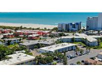 Aerial view of coastal community, showing beach, ocean, and multiple buildings at 680 71St Ave # 14, St Pete Beach, FL 33706