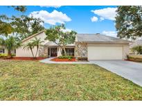 Single-story house with stone accents and a two-car garage at 4604 Westford Cir, Tampa, FL 33618