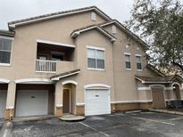 Tan two-story townhome with attached garage and balcony at 10535 Villa View Cir # 10535, Tampa, FL 33647