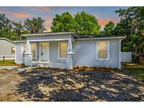 Newly renovated house with a gray exterior, a white door, and a small front porch at 12419 Lamont Ave, New Port Richey, FL 34654