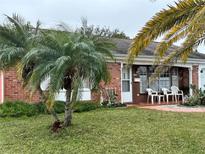 Brick ranch house with mature landscaping and a spacious lawn at 3722 Haven Dr, New Port Richey, FL 34652
