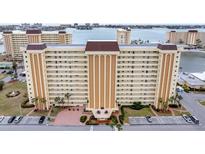 Aerial view of a waterfront condo building with parking and resort-style amenities at 4575 Cove Cir # 407, St Petersburg, FL 33708