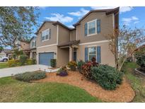 Two-story house with a landscaped front yard and attached garage at 6216 Kevesta Ave, Palmetto, FL 34221