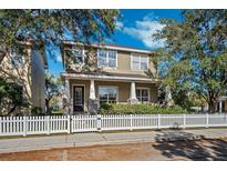 Two-story house with front porch, stone accents, and white picket fence at 10515 Fenceline Rd, New Port Richey, FL 34655