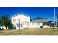 Tan two-story house with multiple windows and a landscaped yard at 1434 Cleveland St # 4, Clearwater, FL 33755