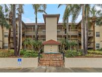 Exterior of a two-story building with a fountain at 2400 Feather Sound Dr # 913, Clearwater, FL 33762