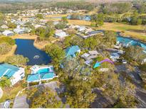 Aerial view of condo community near golf course and pool at 3578 Indigo Pond Dr, Palm Harbor, FL 34685