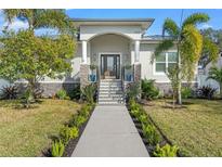 Curb appeal abounds at this beautiful home, featuring a landscaped yard and inviting entryway at 3925 1St Ne St, St Petersburg, FL 33703