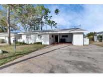 White single story home with carport and small front yard at 4730 Shore Acres Ne Blvd, St Petersburg, FL 33703