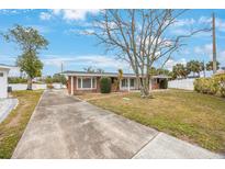 Brick ranch house with a large front yard and driveway at 5290 38Th S Way, St Petersburg, FL 33711