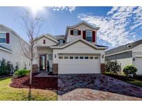 Two-story house with brick driveway and red shutters at 5453 Del Coronado Dr, Apollo Beach, FL 33572