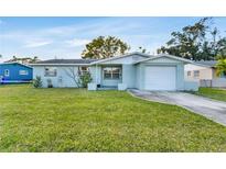 Charming single-story home with a well-maintained lawn and attached one car garage at 5600 Bayou Grande Ne Blvd, St Petersburg, FL 33703