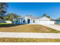 Single-story house with a two-car garage and a well-maintained lawn at 6516 Clair Shore Dr, Apollo Beach, FL 33572