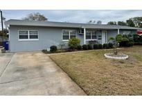 Gray house with a well-maintained lawn and driveway at 6623 16Th N St, St Petersburg, FL 33704