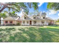 Spacious ranch house with a large front yard and mature trees at 6819 Stafford Rd, Plant City, FL 33565