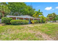 Brick ranch home with lush landscaping and mature trees at 8296 15Th N Way, St Petersburg, FL 33702