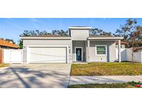 Gray house with white garage door and landscaping at 1103 S Prospect Ave, Clearwater, FL 33756